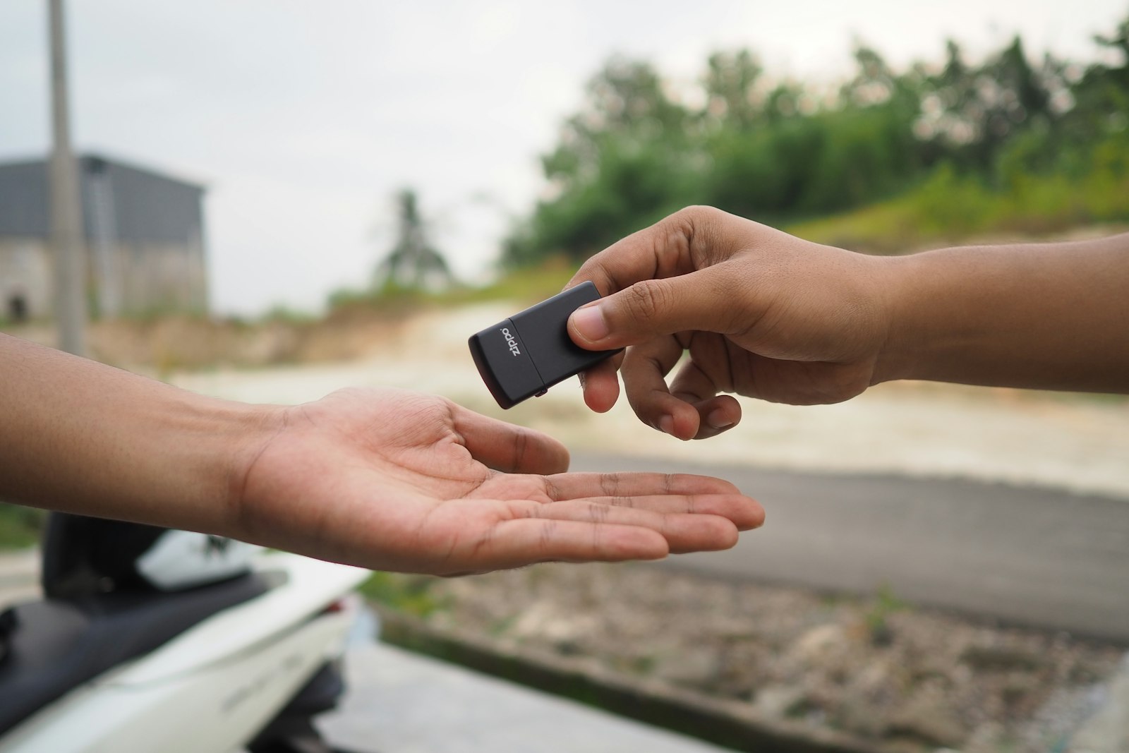 person holding black rectangular device